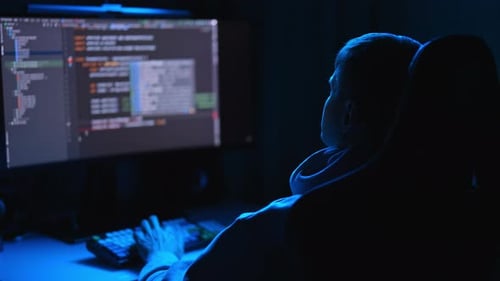 Software Developer Working on Code at Night