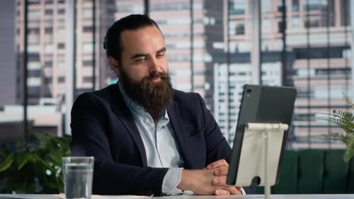Bearded Man Video Conferencing On A Tablet