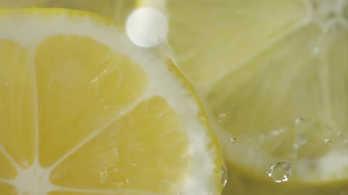Refreshing Lemon Slices with Water Splashes Close Up