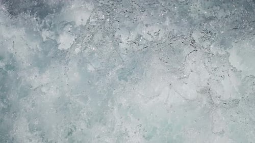 Close-up of splashing water, capturing the chaotic beauty of ocean waves in motion. Slow-motion, loo