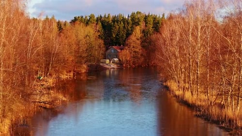 Peaceful River View of Hapaka Grāvis with House, Trees in Riga Latvia at Sunset