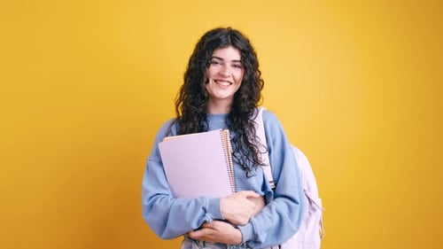 Smiling College Student with Notebook and Backpack