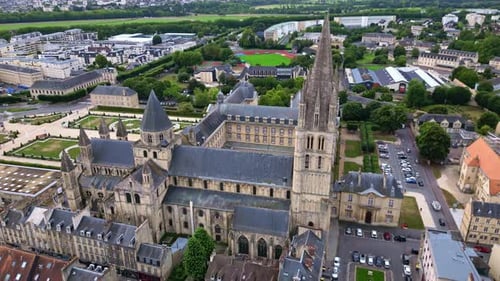 Tracking aerial movement about the L'Abbaye-aux-Hommes abbey with St. Etienne church in the backgrou