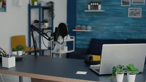 Empty Living Room Studio Desk with Modern Laptop and Professional Podcast Microphone