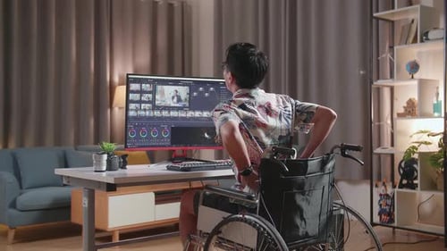 Man in Wheelchair Editing Video at Computer
