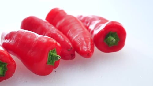 Fresh Red Sweet Peppers on White Surface