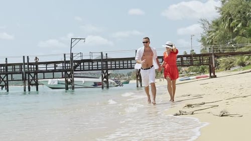 Happy Loving Couple Running on the Beach