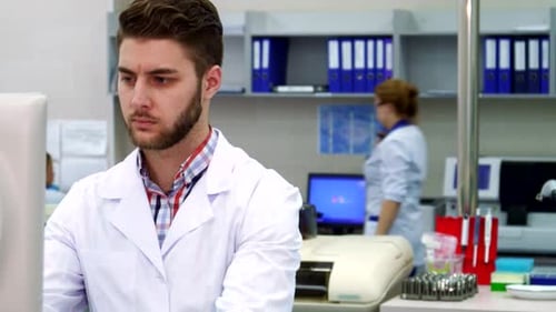 Man Works On Computer in Modern Laboratory