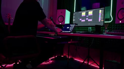 professional sound recording studio sound engineer or music producer sitting at the remote control