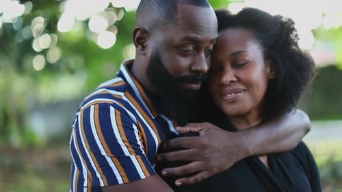 Affectionate couple together ar park. African relationship love and care