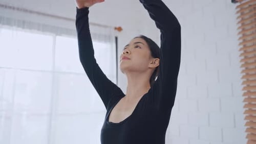 Elegant Woman Exercising in Bright Indoor Room