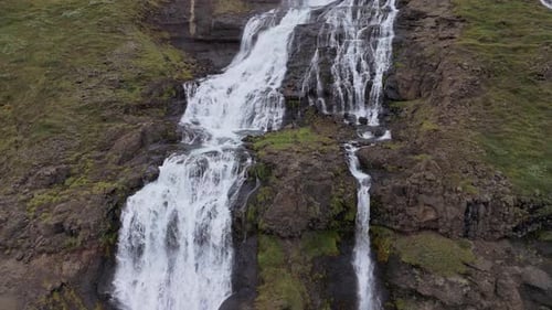 Aerial View Of Waterfall In Iceland With Volcanic Glacier On The Horizon