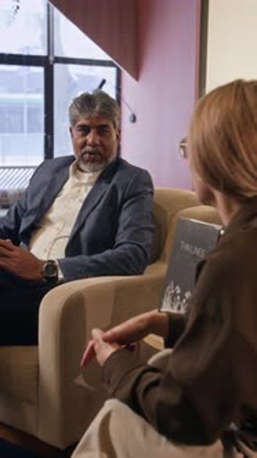 Two Colleagues Talking in an Office Space