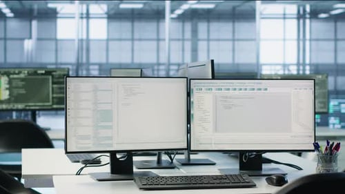 Tech Office with Computer Monitors Displaying Code