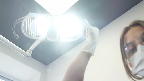 Medical Professional Adjusts Examination Light in Hospital