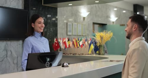 Administrator Giving Tourist Man Key Card at Hotel Desk Concierge Service Woman Smile in Lobby for