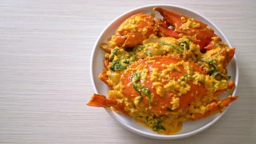 Crab Covered in Yellow Curry on White Plate