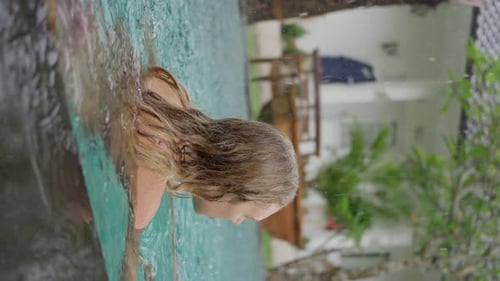 Sexy Girl Swimming in Outdoor Pool in the Rain Slow Motion Vertical Video