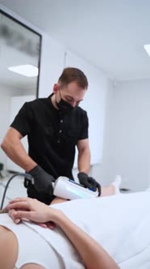 Medical Professional Performs Leg Procedure in Office