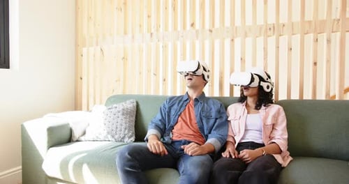 Couple Wearing VR Headsets Enjoying Virtual Reality Experience