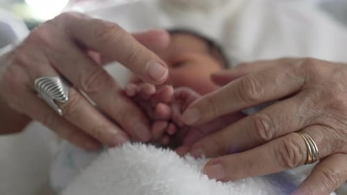 Close-Up of Infant Being Held by Adult