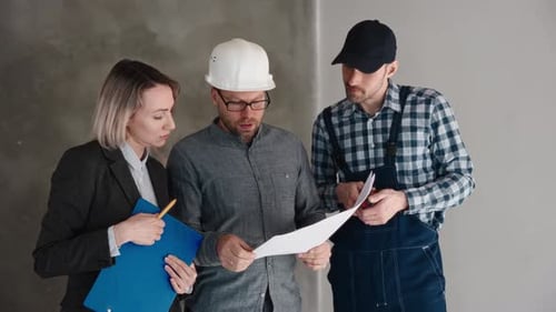 Architects and Construction Workers Reviewing Plans