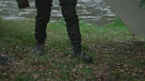 Man Builds Fire Pit with Stones in Nature