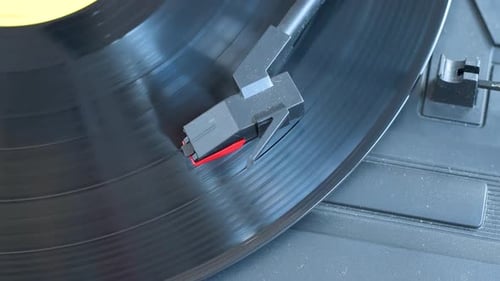 Top view of vinyl record spinning on turntable.