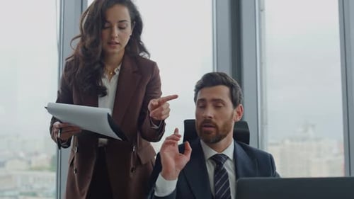 Business Colleagues Discussing Work in a Bright Office