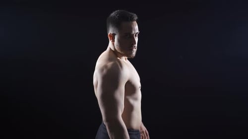 Athlete looking confidently at camera with angry and fiery eyes. Aggressively focused books.