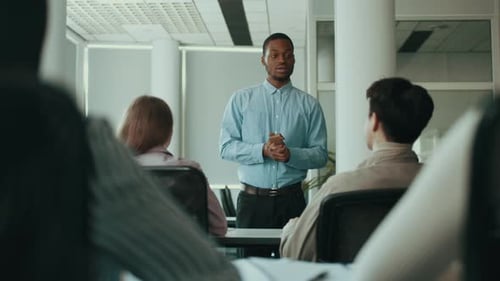 College Students Engage in Group Discussion Led By a Diverse Instructor