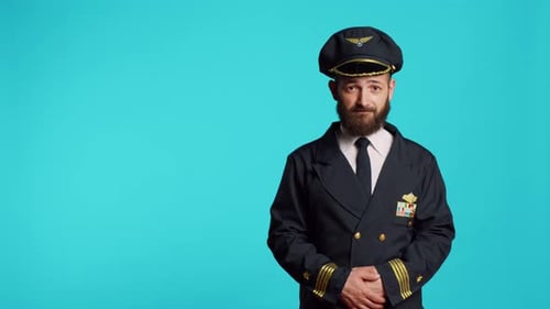 Männlicher Flugzeugkapitän trägt Airline-Uniform und posiert