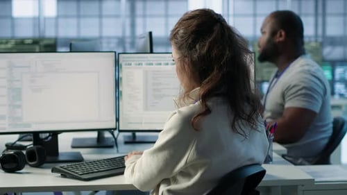 Woman Typing at Computer in Modern Workplace