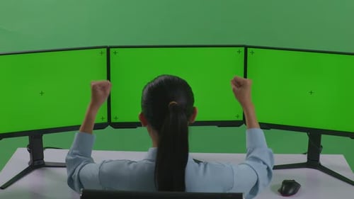 Happy Woman Celebrating And Dancing While Working With Mock Up Multiple Monitor In Green Screen
