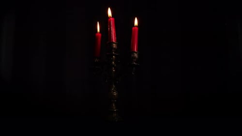 Ornate Candelabra with Three Burning Red Candles