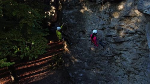 Climbing Activity Young Extreme Couple of Hikers Family Getting Down Mountain Stone Rock Climbing
