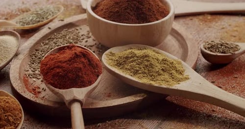 Wooden Spoons and Bowl Filled with Various Spices
