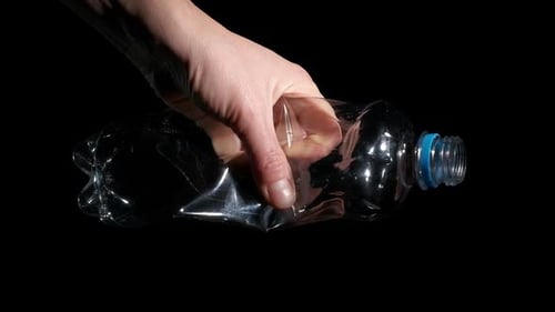 Hand Crushing an Empty Plastic Bottle