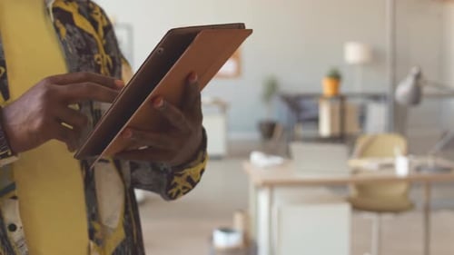 Black Man Using Digital Tablet in Office