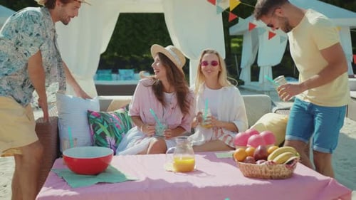 Friends Toasting Drinks at Sunny Beach Party