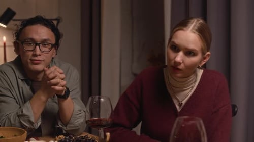 Friends Talking at Dinner Party with Wine and Candles