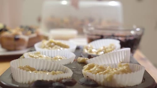 Preparing Homemade Blueberry Muffins, Filling Muffin Liners