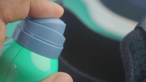 Spraying Deodorant on Sweaty Shoes