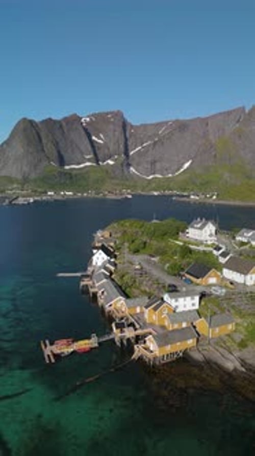 Breathtaking Coastal Village in Norway with Stunning Mountain Backdrop