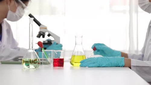 Scientists Working With Chemical Solution in a Lab