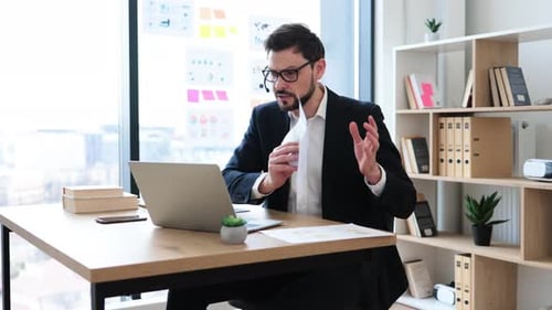 Man in Suit Explaining Data on Video Call