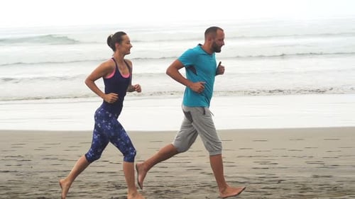 Sportive Couple Jogging On Beach, Super Slow Motion 240fps