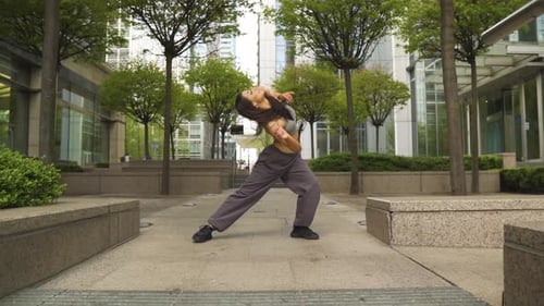 Woman Dancing in City Plaza