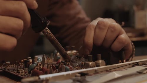 Electronics Repair with Soldering Iron Close Up