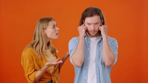 Arguing Couple, Man Plugs Ears, Tongue Out